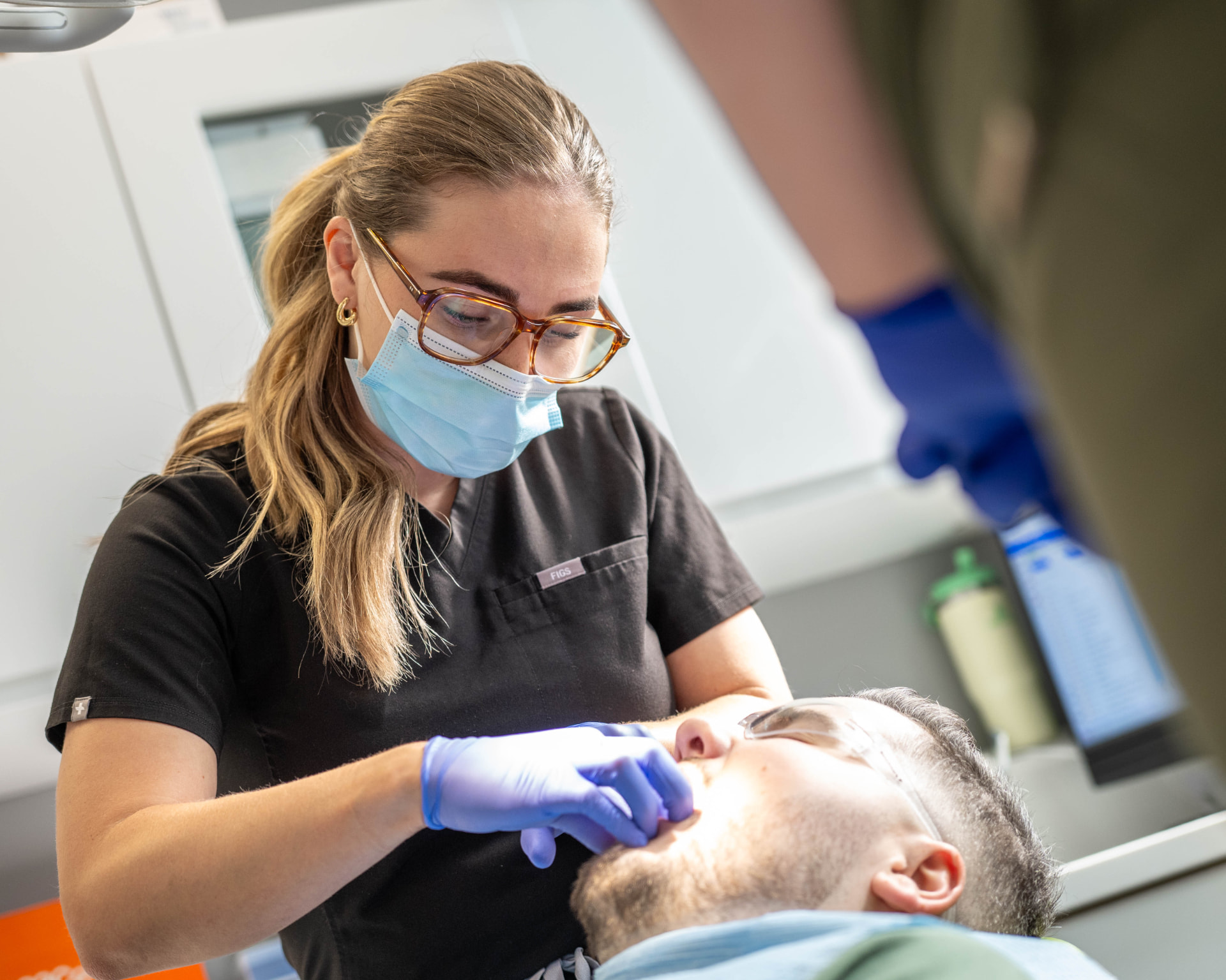 Dentist treating a patient at Stable Court