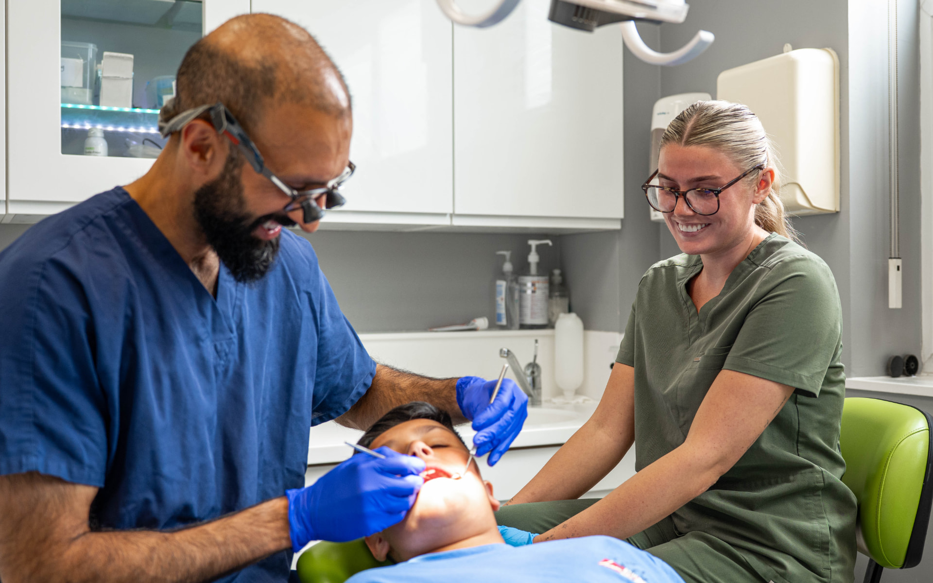 Dentist and nurse treating a young patient